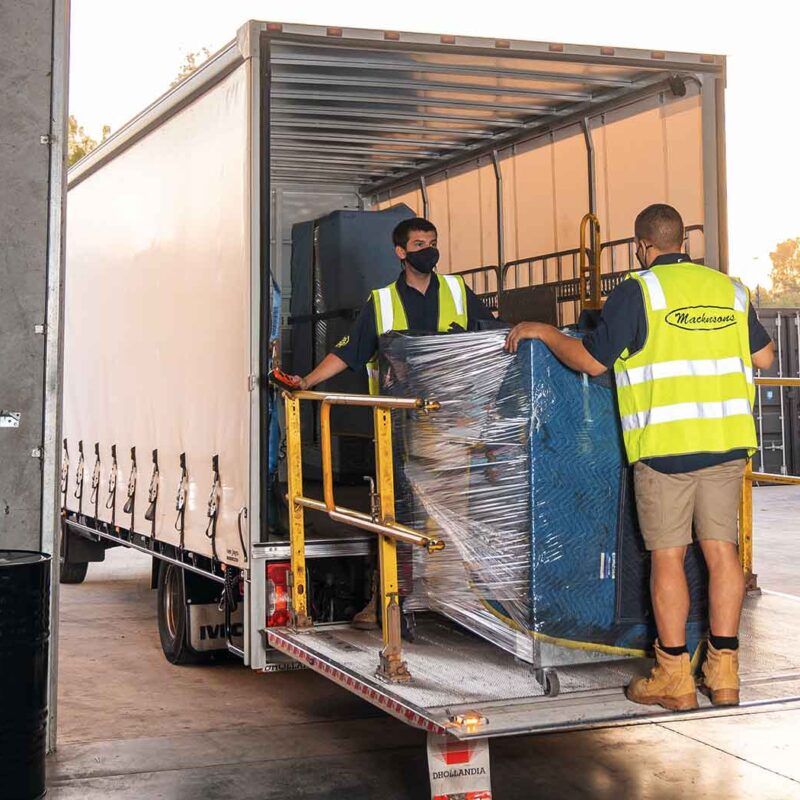 People loading freight onto a truck