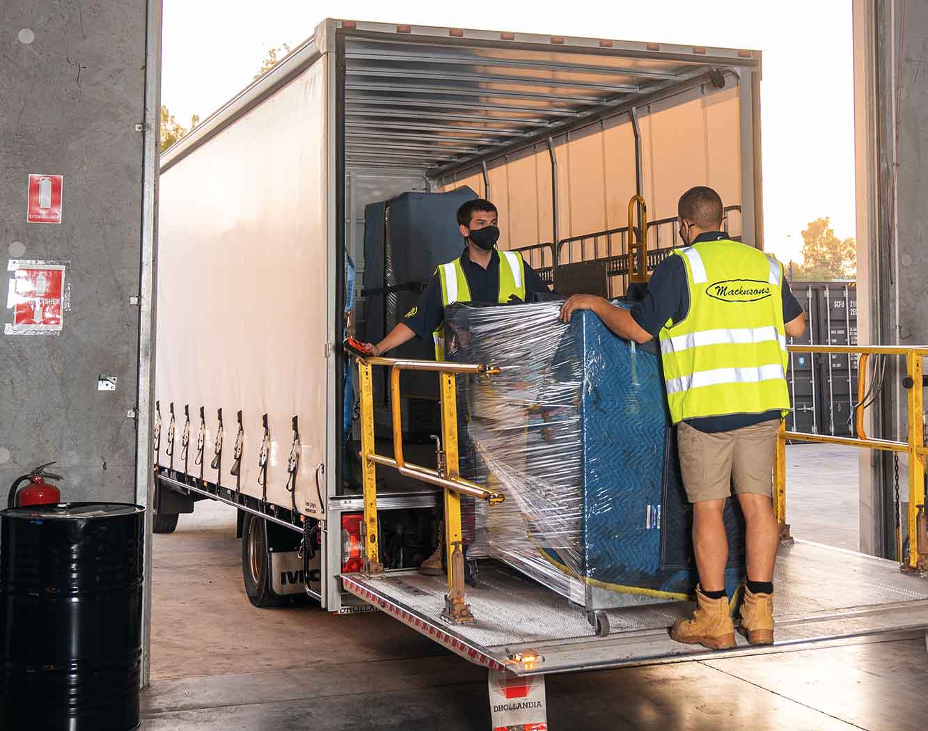 People loading freight onto a truck