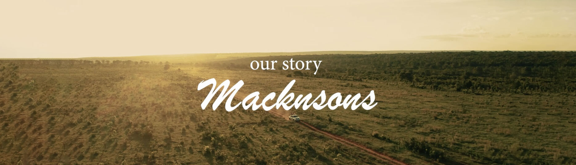 Sunset over a large field with Macknsons logo overlaid